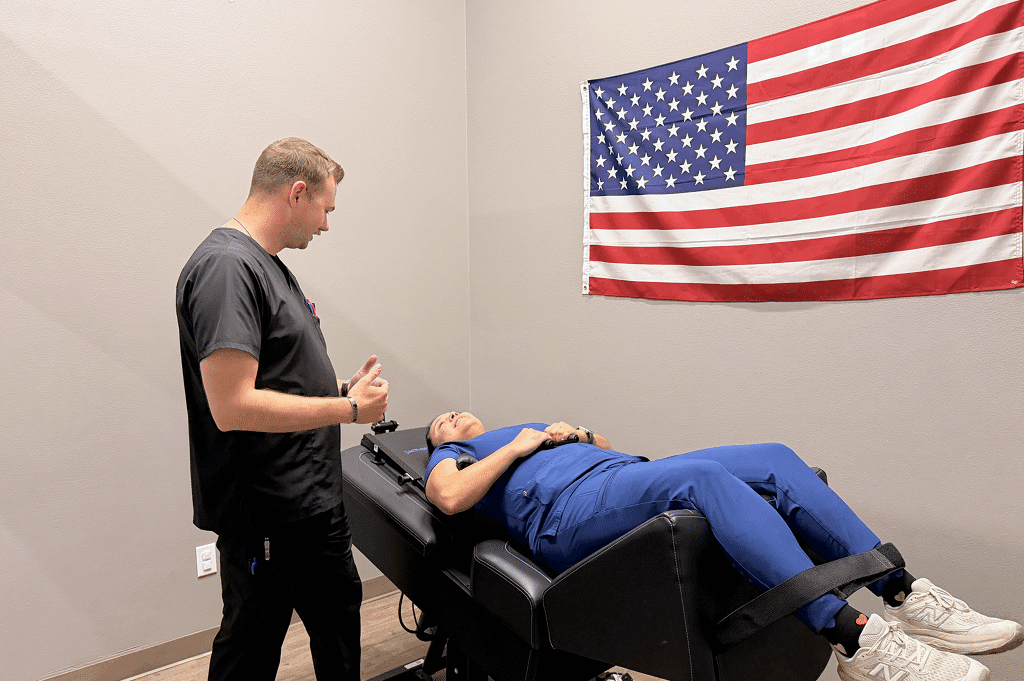 A doctor at Authority Chiropractic explaining spinal decompression to a patient